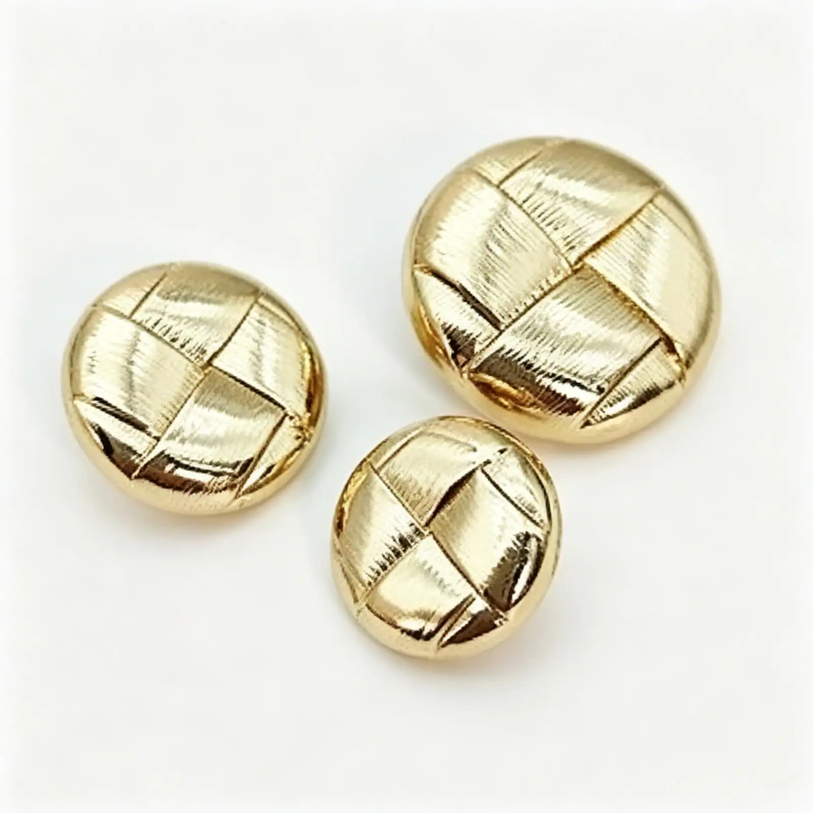 Round woven gold buttons in three sizes with a domed criss-cross woven face for coats and sewing