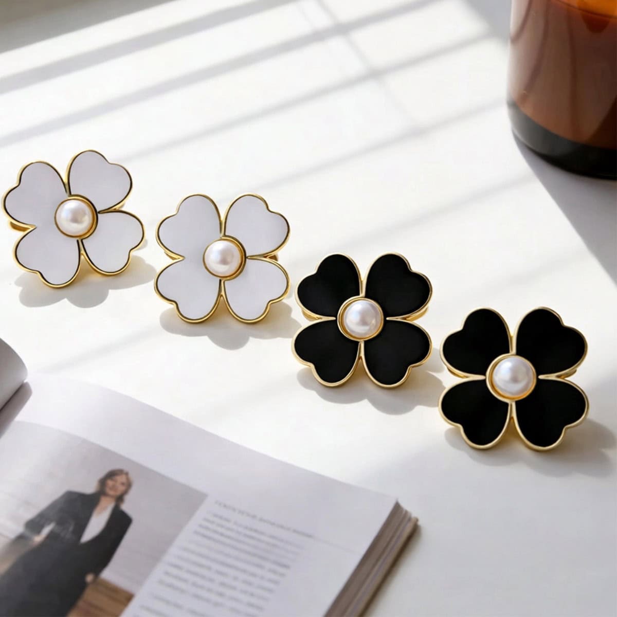 White and black flower-shaped pearl buttons with gold rims